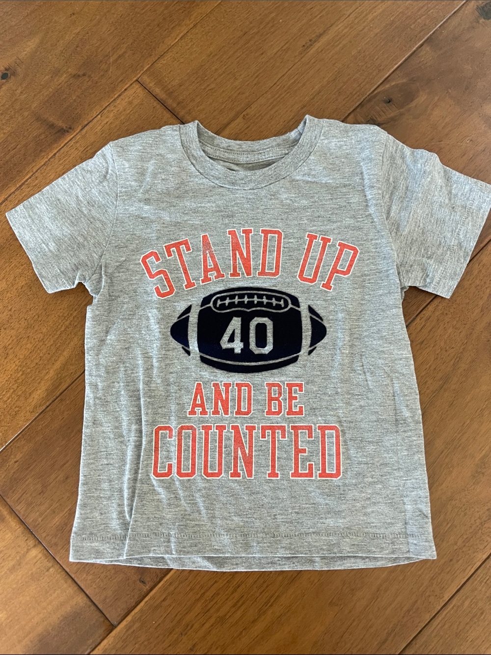 Peek Gray Tee with Red Lettering & Navy Football Graphic